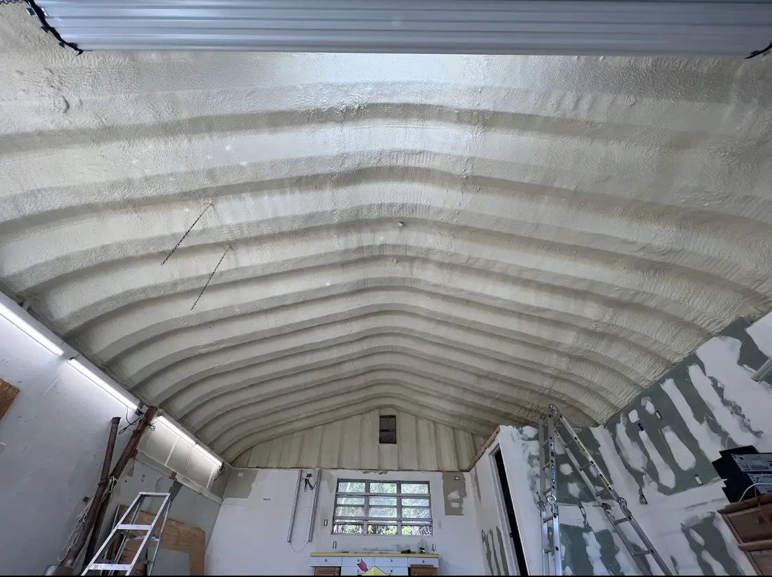 Spray polyurethane foam applied to the underside of a metal roof deck in Anderson